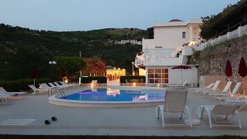Seasonal outdoor pool, open 8:00 AM to 11:00 PM, pool umbrellas
