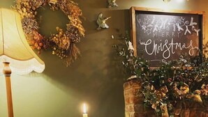 A dining table with a candle, a menu, and a 'Reserved' sign.
