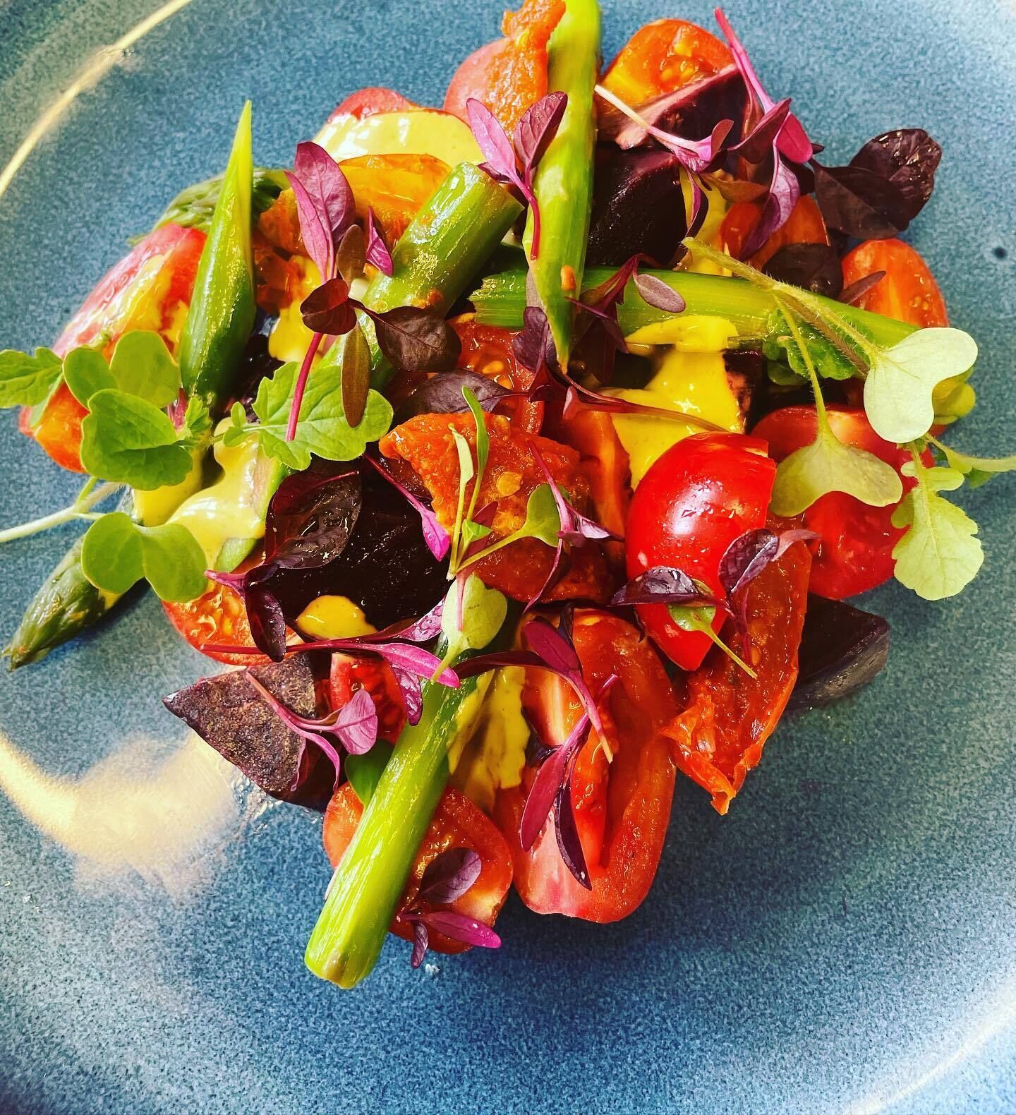 A colorful salad with various vegetables and greens.