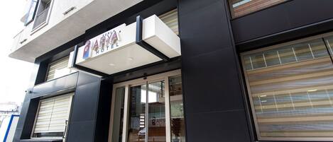 A hotel entrance with a sign reading "PARYA HOTEL".