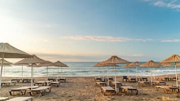 On the beach, sun-loungers, beach umbrellas