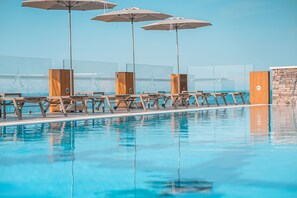 Seasonal outdoor pool, pool umbrellas, pool loungers