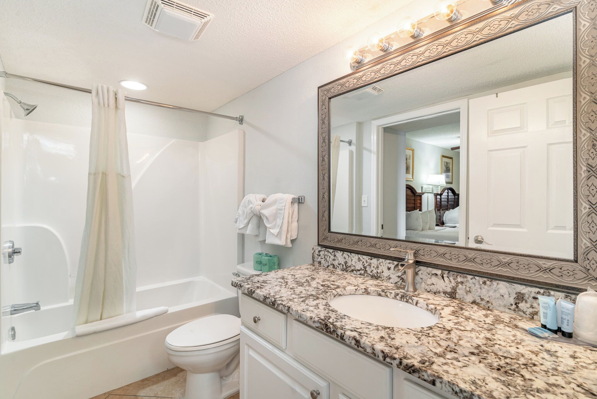 A bathroom with a bathtub, toilet, and sink.