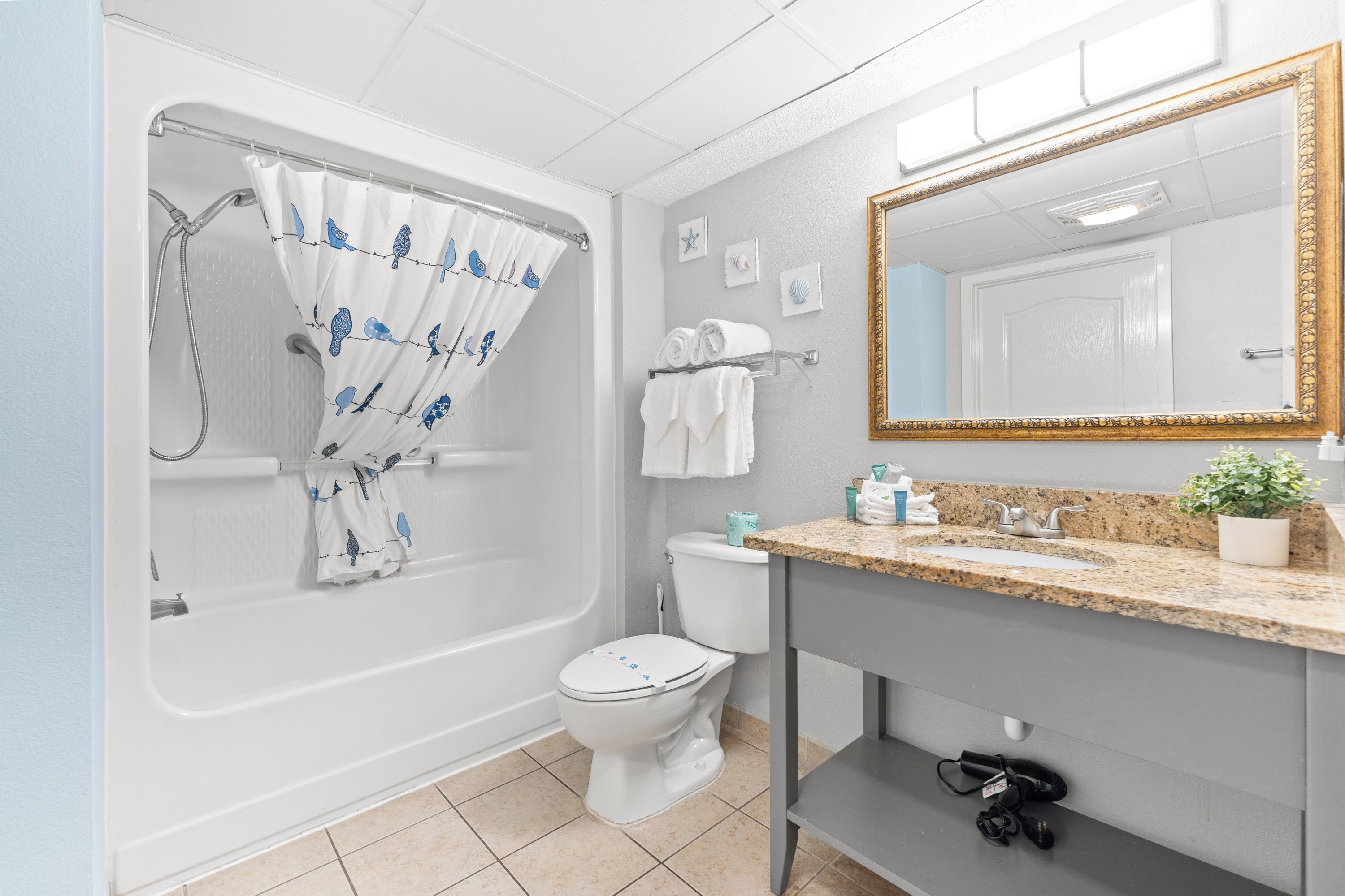 A bathroom with a bathtub, toilet, and sink.