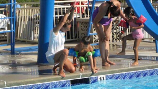 A swimming pool with a blue and white tiled edge. - Attache Motel (Wildwood Crest)
