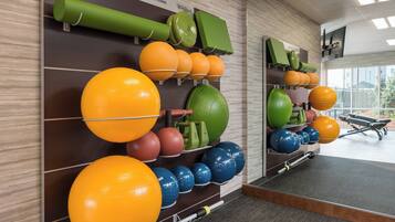 A gym with various exercise balls and equipment.