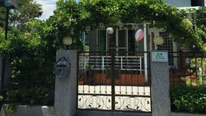 A multi-story building with a gated entrance, a mailbox, and a street lamp. - 3520 B&B (Taitung)