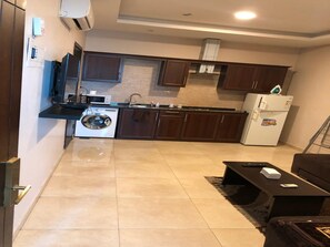 Standard Apartment | Private kitchen | Full-size fridge, microwave, stovetop, electric kettle - Panda Hotel Apartments (Amman)