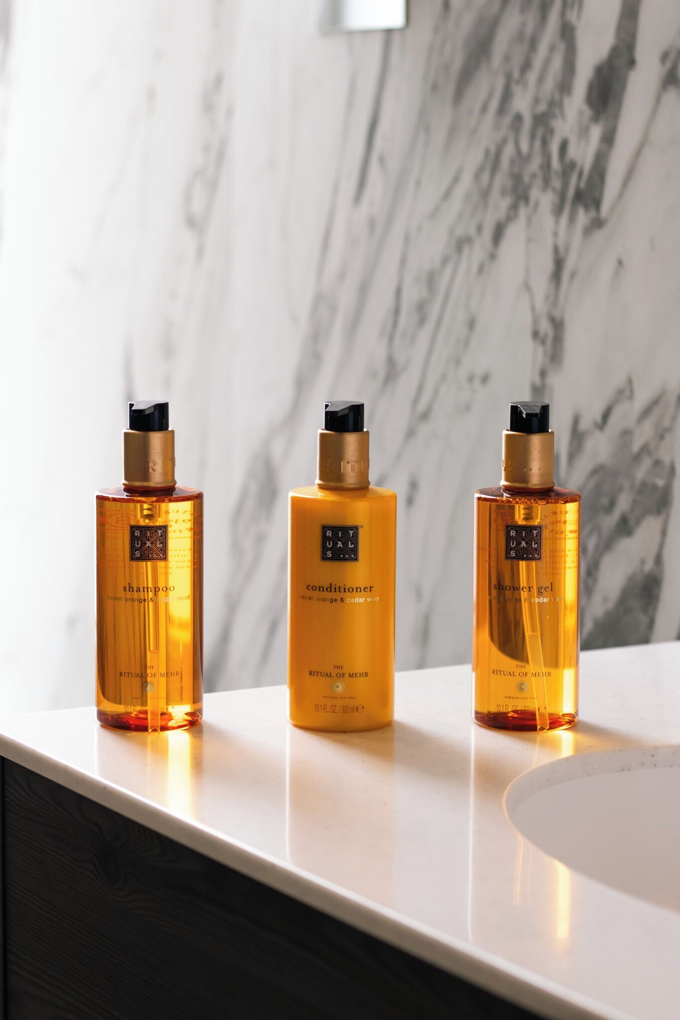 Three bottles of Ritual of Meer products on a bathroom counter.