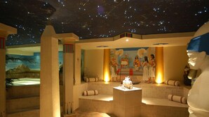 A museum exhibit with a starry ceiling, ancient Egyptian wall paintings, and a central statue. - Park Hotel Arnica (Falcade)