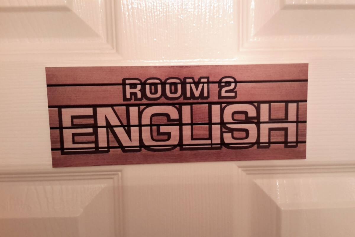 A sign on a door indicating 'ROOM 2 ENGLISH'.