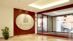 A lobby with a 'Funway' sign, a potted plant, and a glass door entrance. - Funway Academic Resort - Adults Only (Madrid)