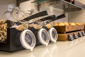 A breakfast buffet with various food items and a coffee station.