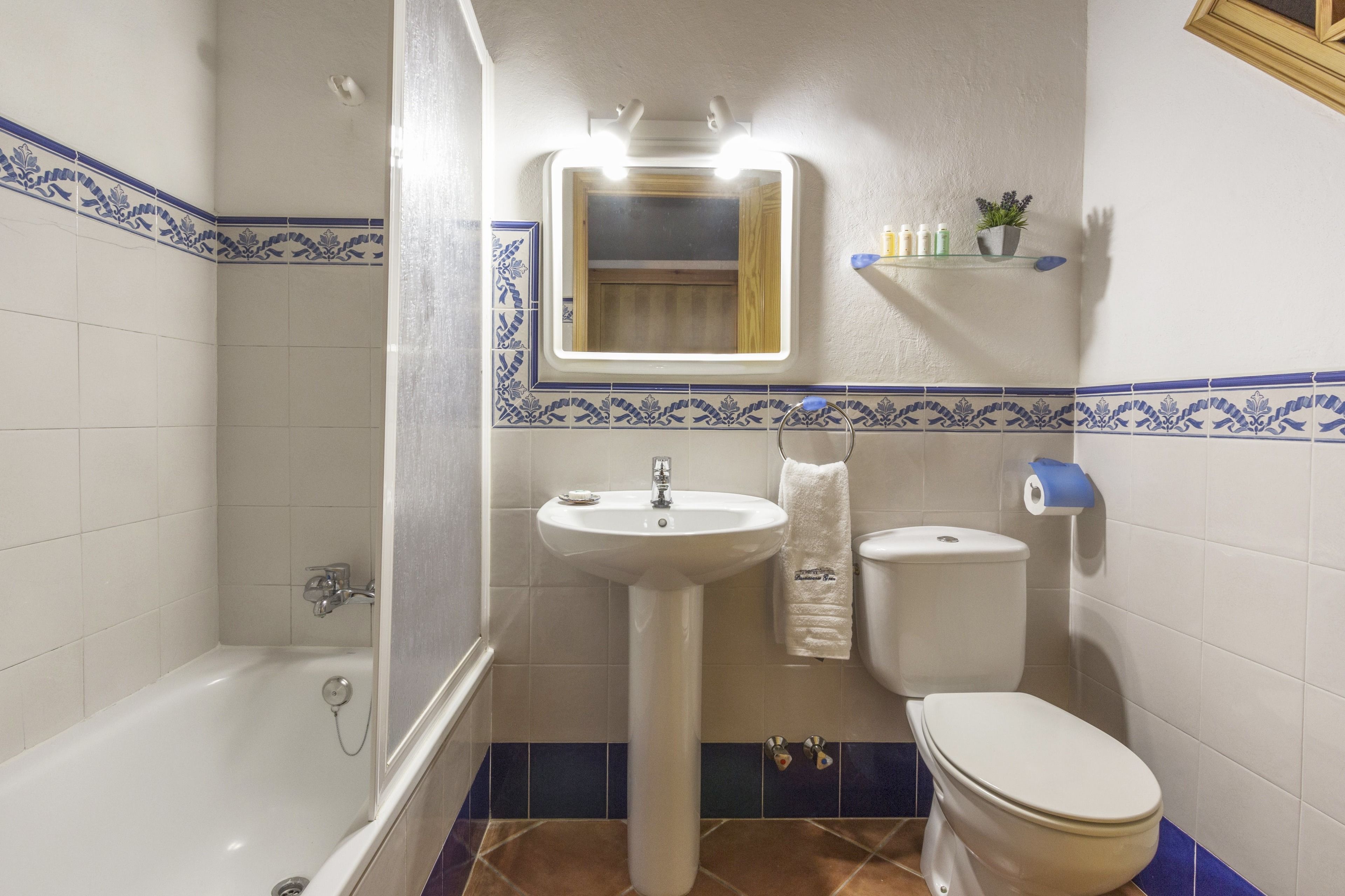 A bathroom with a bathtub, sink, and toilet.