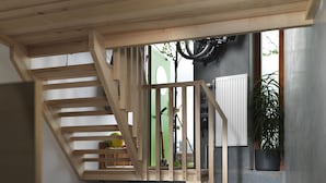 A bedroom with a bed, a wooden staircase, and a view of the outside. - Ohboy Hotell (Malmö)