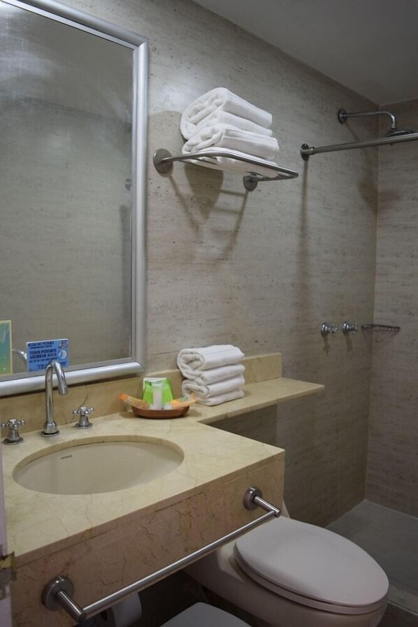 A bathroom with a sink, mirror, towel rack, and toilet. - Hotel Decameron Marazul (San Andres)