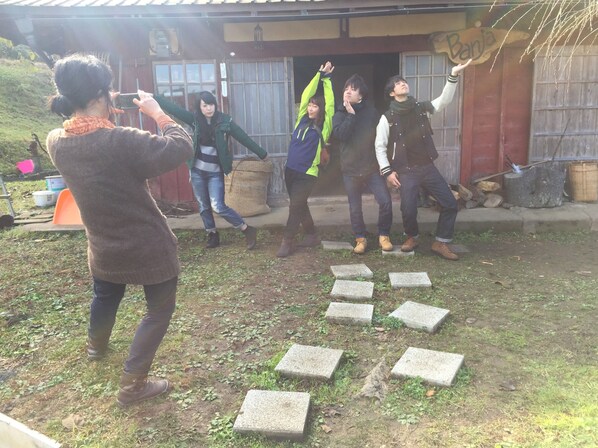 A group of people playing a game outdoors with stepping stones on the ground. - banja (Kyoto)