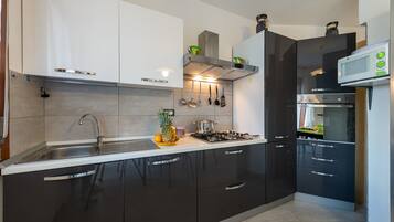 Apartment, 2 Bedrooms | Private kitchen | Full-size fridge, microwave, stovetop, dishwasher