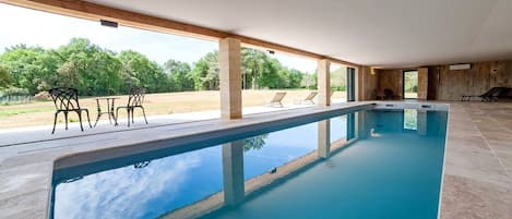 Indoor pool, pool umbrellas, pool loungers