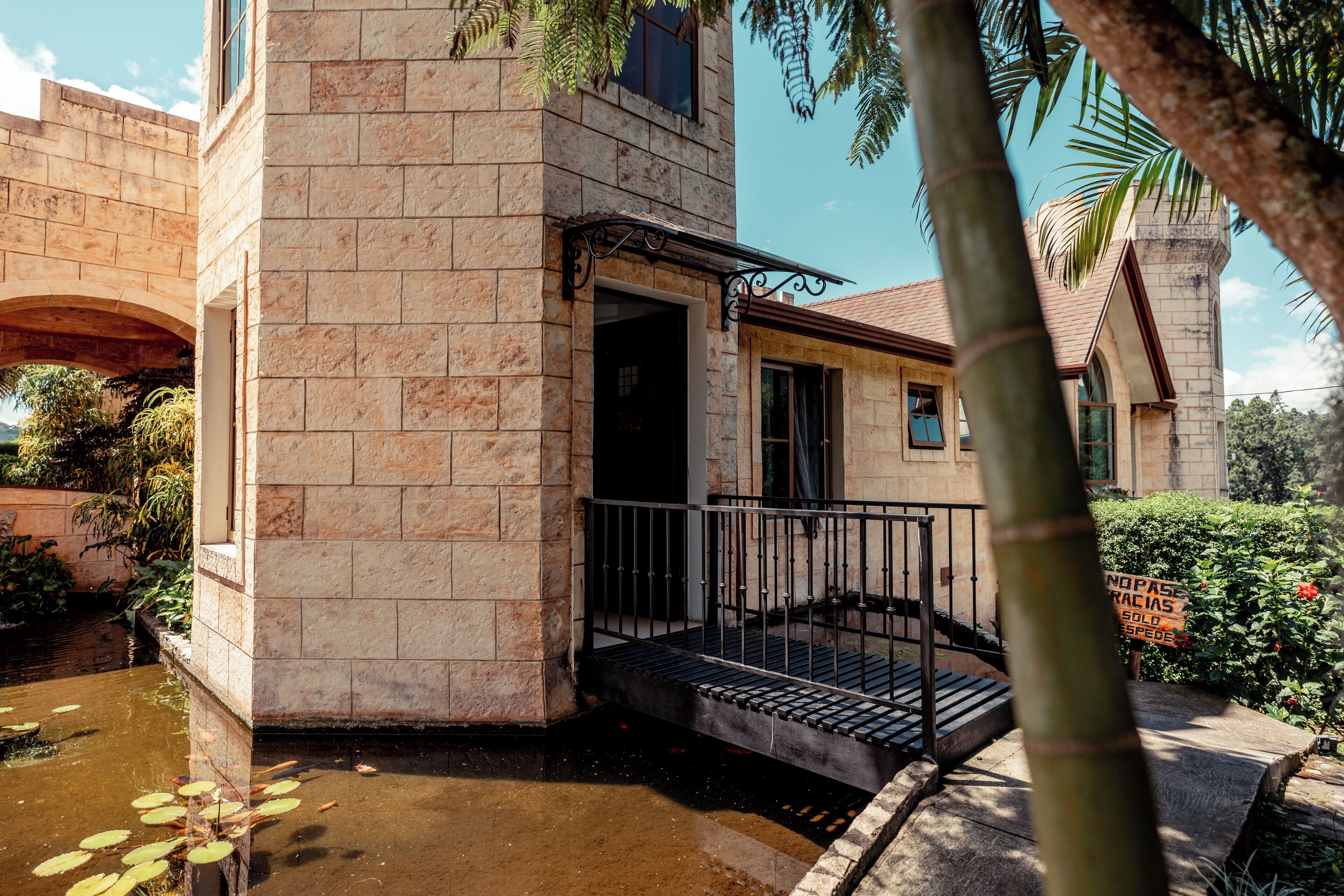 A stone building with a stone staircase leading to a balcony.