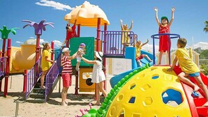 Un área de juegos infantiles con diversas estructuras y equipo de colores.