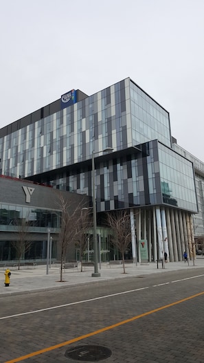 A modern building with a glass facade and a logo on the top. - Residence & Conference Centre Toronto Downtown George Brown Polytechnic Campus Accommodation (Toronto)