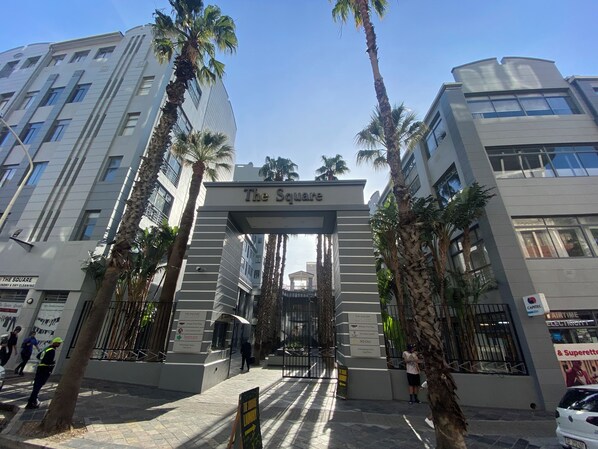 A modern building entrance with a sign reading "The Square."