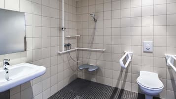 A modern bathroom with a sink, toilet, and shower.