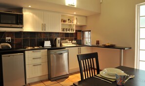 Comfort Cottage, 1 Bedroom, Kitchenette, Garden Area | Private kitchen | Fridge, microwave, stovetop, dishwasher
