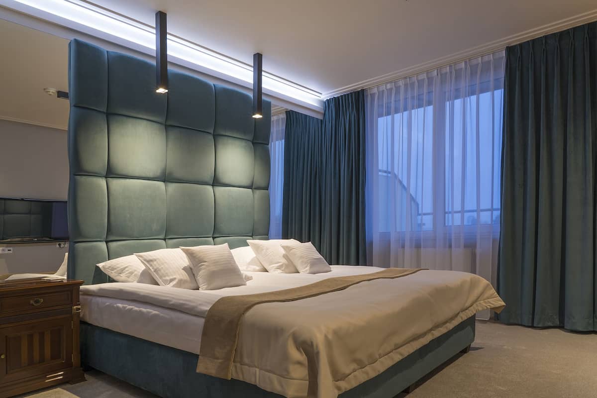 grand studio suite, 1 bedroom, partial lake view | 1 bedroom, premium bedding, desk, iron/ironing board