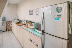 Compact kitchen with modern appliances, sink, and ample storage.
