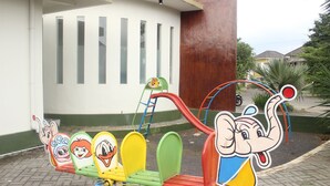 A children's playground with a seesaw and a large elephant figure. - Sierra Villa Malang (Malang)