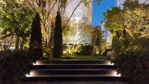 A set of outdoor stairs leading up to a building, surrounded by trees and illuminated by lights. - Hotel Museo (Cheongju)