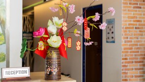 A reception area with a vase of flowers and a sign that reads "RECEPTION".
