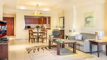 A modern living room with a sofa, coffee table, and dining area.