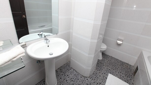 A bathroom with a white sink, toilet, and bathtub. - The Hotel Emperor Inle (Nyaungshwe)