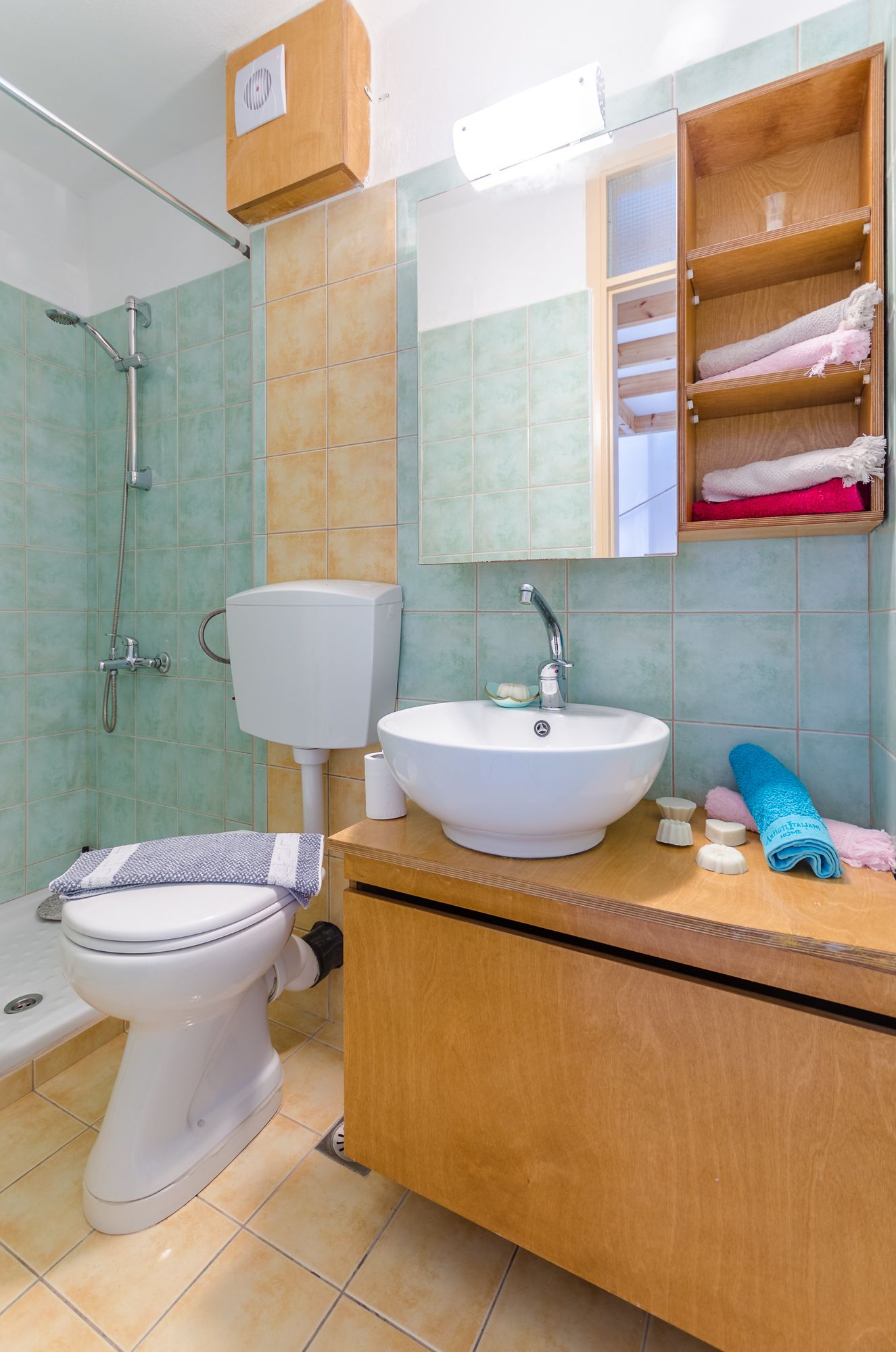 A bathroom with a toilet, sink, and shower.