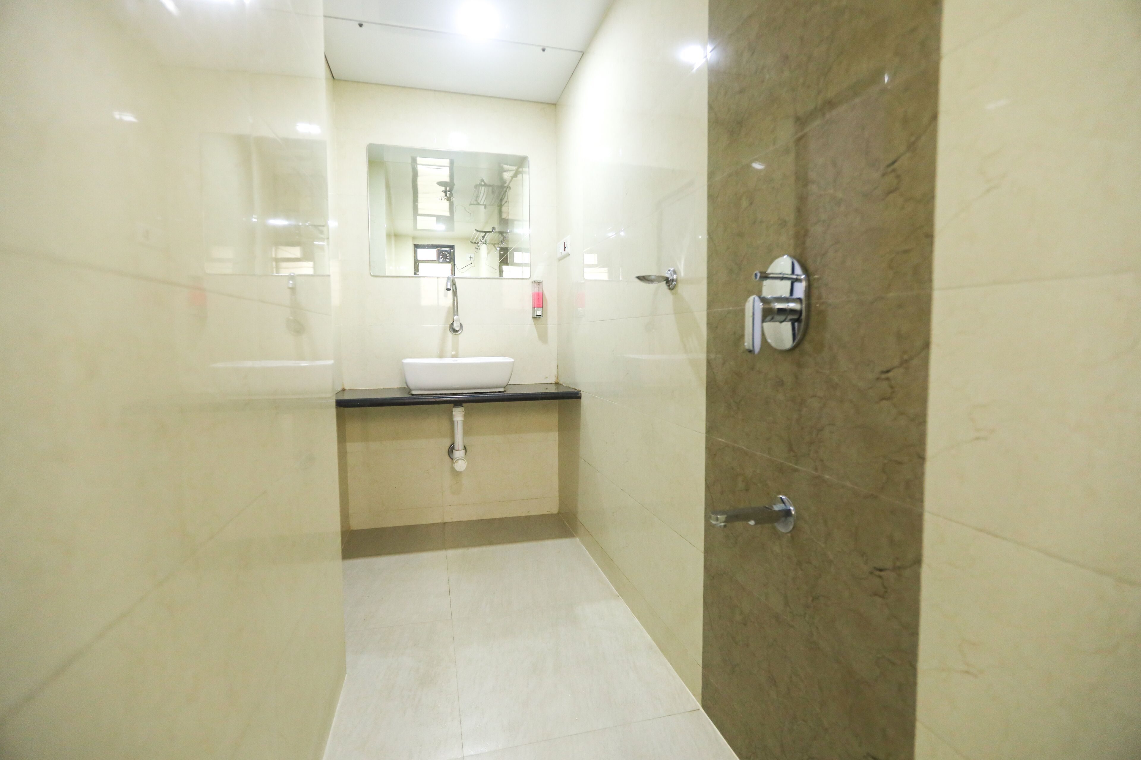 A modern bathroom with a sink, mirror, and shower.