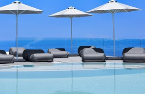 Outdoor pool, open 9:00 AM to 9:00 PM, pool umbrellas, pool loungers