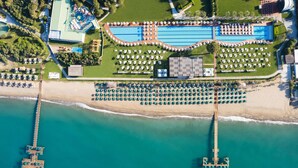 An aerial view of a resort with a swimming pool, beach area, and a pier. - Club Privé By Rixos Belek - All Inclusive (Serik)