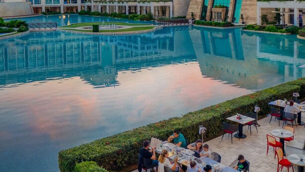 A hotel with a large pool, outdoor dining area, and modern architecture. - Club Privé By Rixos Belek - All Inclusive (Serik)