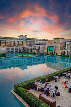 A hotel with a large pool, outdoor dining area, and modern architecture. - Club Privé By Rixos Belek - All Inclusive (Serik)