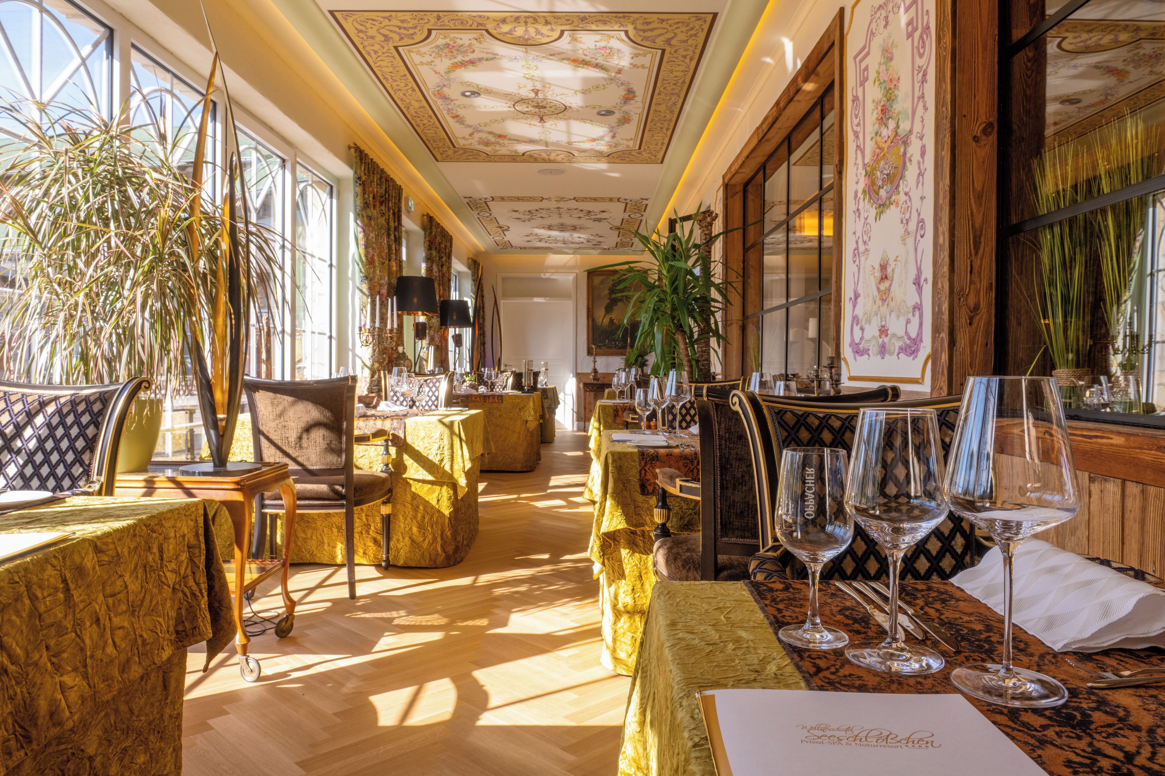 A luxurious hotel room with a large window, elegant furniture, and a well-decorated interior.