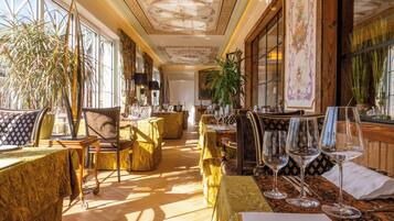A luxurious hotel room with a large window, elegant furniture, and a well-decorated interior.