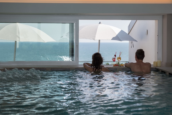 Indoor pool, a rooftop pool, open 8:00 AM to 10:00 PM, pool umbrellas