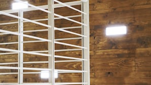 A wooden wall with a metal shelf structure.