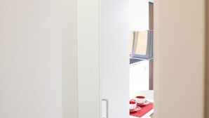 A white door leading to a room with a red table and white chairs. - Alessia's Flat - Paolo Sarpi (Milan)