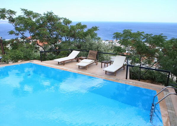 Seasonal outdoor pool, pool loungers