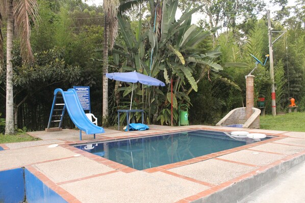 Utomhuspool, parasoller och solstolar