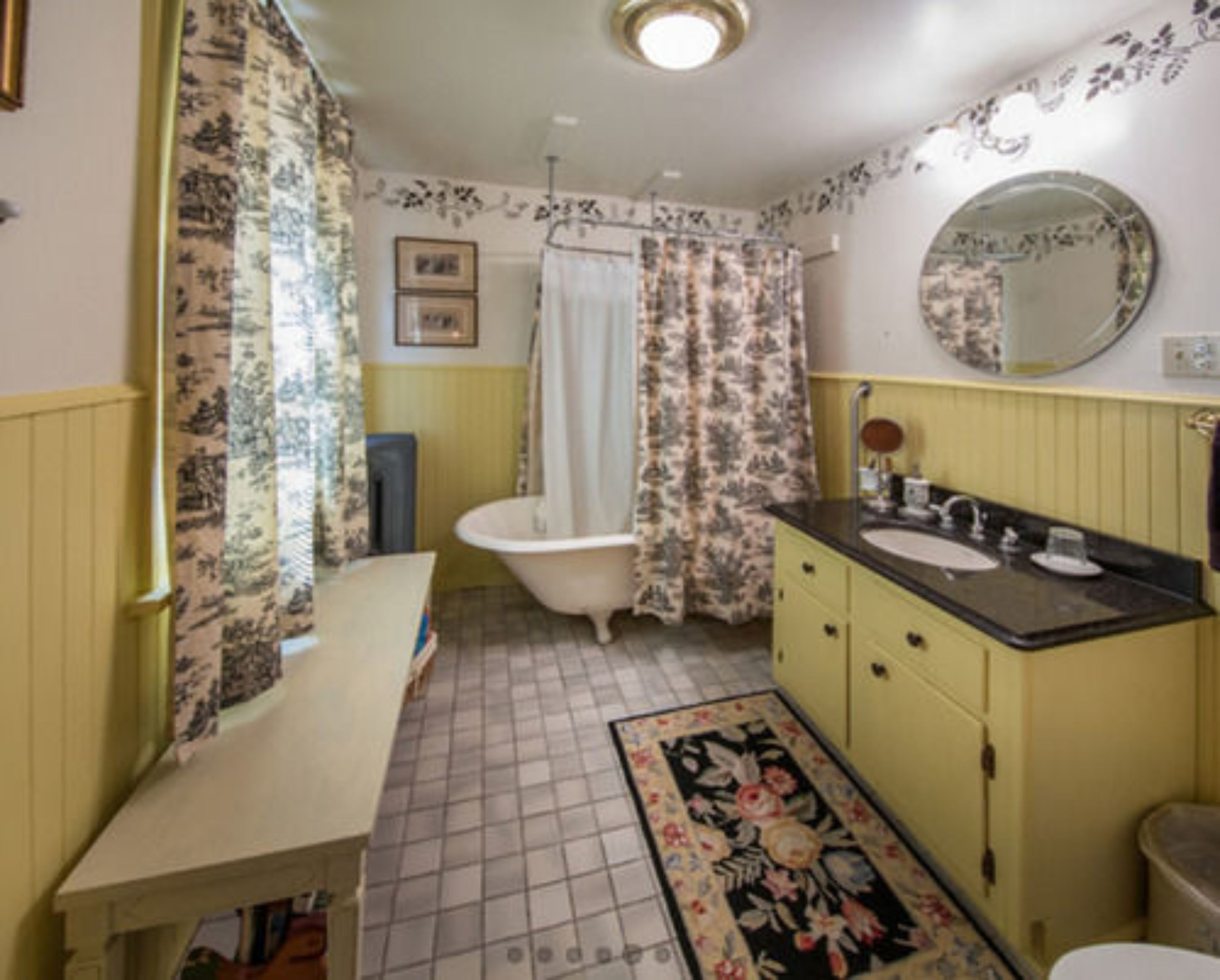 A bathroom with a bathtub, sink, and toilet.